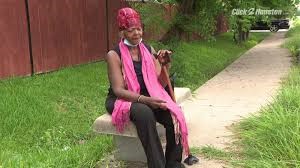Ms. Janis Scott, LINK Houston Board member, sits on a bench waiting for METRO. Photo credit: KPRC.