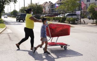 "People cross the street along Gulfton near Westward on June 17, 2021 in Houston. About 12 percent of households in Gulfton do not have a car, about double the average for Harris County. Melissa Phillip, Houston Chronicle / Staff photographer"