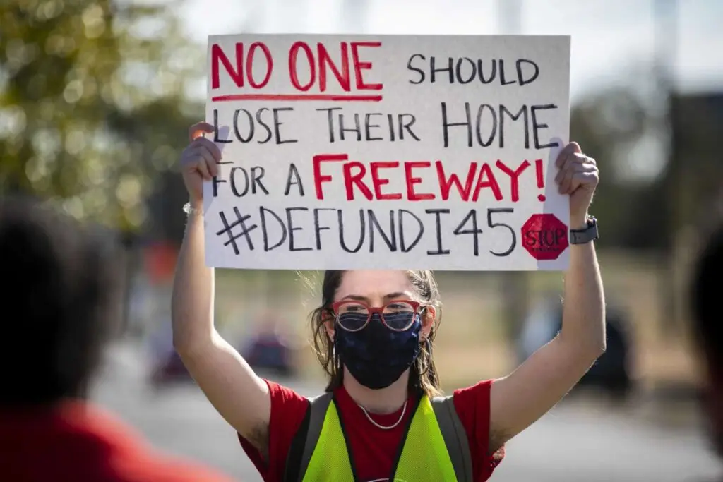 "Organizer Chloe Cook holds a sign during a protest walk of the Interstate 45 expansion in Fifth Ward on Dec. 6, 2020. Annie Mulligan, Houston Chronicle / Contributor"