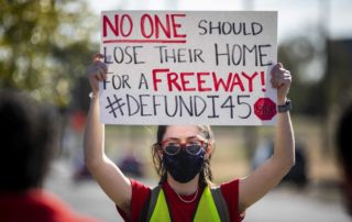 "Organizer Chloe Cook holds a sign during a protest walk of the Interstate 45 expansion in Fifth Ward on Dec. 6, 2020. Annie Mulligan, Houston Chronicle / Contributor"