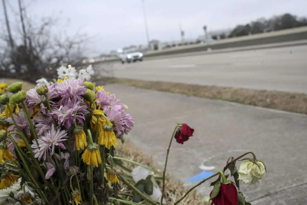 "Traffic passes by a memorial at the site of a crash that resulted in the deaths of three people. Jon Shapley, Houston Chronicle / Staff photographer"