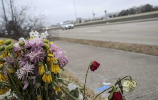 "Traffic passes by a memorial at the site of a crash that resulted in the deaths of three people. Jon Shapley, Houston Chronicle / Staff photographer"
