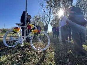 "Family members of Joel Middaugh, a Houston father and art model, watch as Steve and Melissa Sims install a ghost bike is installed in the 2800 block of West Little York Road, near the site where Middaugh died, on Dec. 12, 2021. Jay R. Jordan / Chron staf"