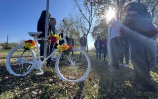 "Family members of Joel Middaugh, a Houston father and art model, watch as Steve and Melissa Sims install a ghost bike is installed in the 2800 block of West Little York Road, near the site where Middaugh died, on Dec. 12, 2021. Jay R. Jordan / Chron staf"