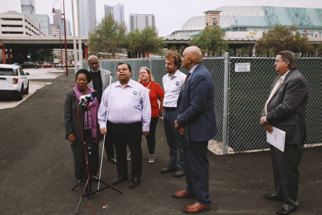 Executive Director Gabe Cazares at the lot which used to be half of the Lofts at the Ballpark housing complex with Congresswoman Jackson-Lee, FHWA Administrator Bhatt and, METRO President Lambert.