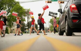 "Desiree Alejandro holds up a sign urging people to "Stop TXDOT" while crossing a crosswalk during a demonstration at the intersection of Polk Street and St. Emmanuel Street just east of downtown Houston in 2020. Mark Mulligan, Houston Chronicle / Staff photographer"