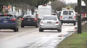 Cars on a busy Houston road on a rainy day.